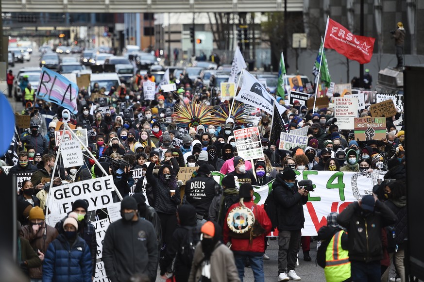 epa09146429 Protesters march through the streets after attorneys finished closing arguments and the jury began deliberations for the murder trial of former Minneapolis police officer Derek Chauvin who ...