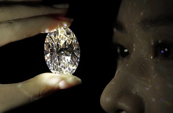 A 102.39 carat, D color, flawless diamond is displayed by a model at a Sotheby