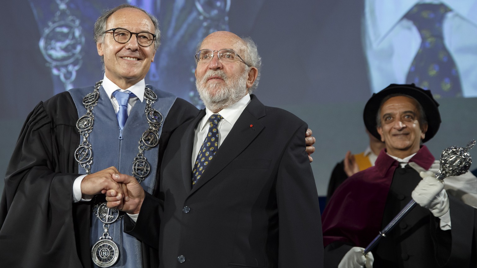 epa07912846 Yves Flueckiger (L), Rector of the university of Geneva, welcomes Swiss astrophysicist Michel Mayor, Nobel Prize 2019 in Physics laureate, speaks during the ceremony Dies Academicus at the ...