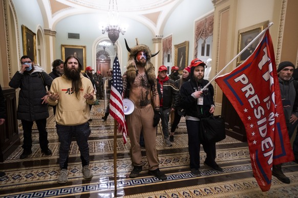 epaselect epa08923457 Supporters of US President Donald J. Trump stand by the door to the Senate chambers after they breached the US Capitol security in Washington, DC, USA, 06 January 2021. Protester ...