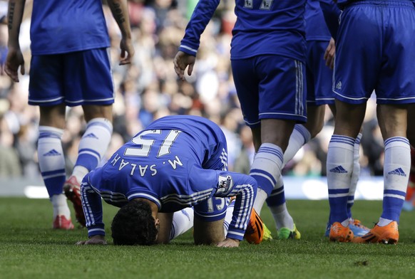 Chelsea&#039;s Mohamed Salah kisses the grass after scoring a goal during the English Premier League soccer match between Chelsea and Arsenal at Stamford Bridge stadium in London, Saturday, March 22,  ...