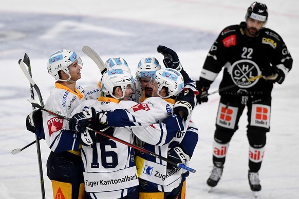 Zug&#039;s player Raphael Diaz, center, celebrates the 1-5 goal with his teammates, during the preliminary round game of National League Swiss Championship between HC Lugano and EV Zug, at the Corner  ...