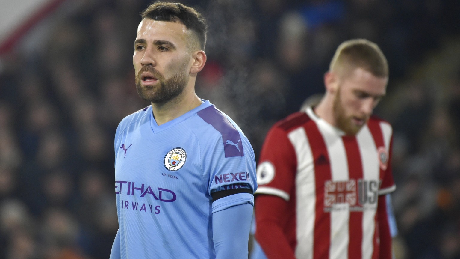 Manchester City&#039;s Nicolas Otamendi, left, during the English Premier League soccer match between Sheffield United and Manchester City at Bramall Lane in Sheffield, England, Tuesday, Jan. 21, 2020 ...