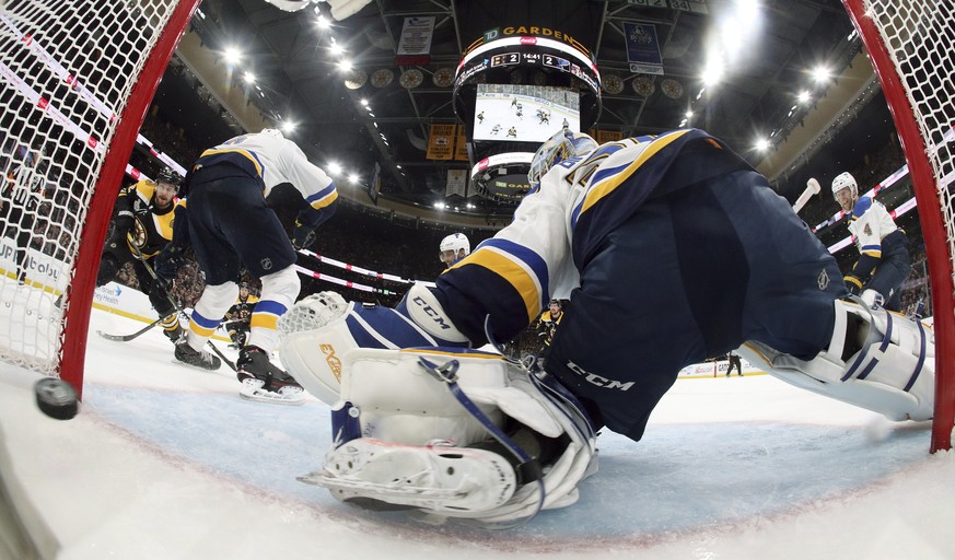 Boston Bruins&#039; Sean Kuraly, left, scores a goal past St. Louis Blues goaltender Jordan Binnington during the third period in Game 1 of the NHL hockey Stanley Cup Final, Monday, May 27, 2019, in B ...