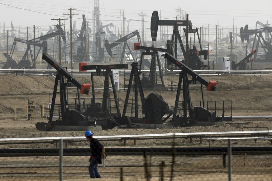 FILE - This Jan. 16, 2015, file photo shows pumpjacks operating at the Kern River Oil Field in Bakersfield, Calif., which is overseen by the U.S. Bureau of Land Management. Oil production from federal ...