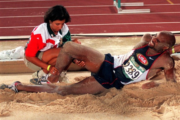 Mike Powell of the United States grimaces after injuring himself during the men&#039;s long jump final at the 1996 Summer Olympic Games in Atlanta, Monday, July 29, 1996. (AP Photo/Lynne Sladky)