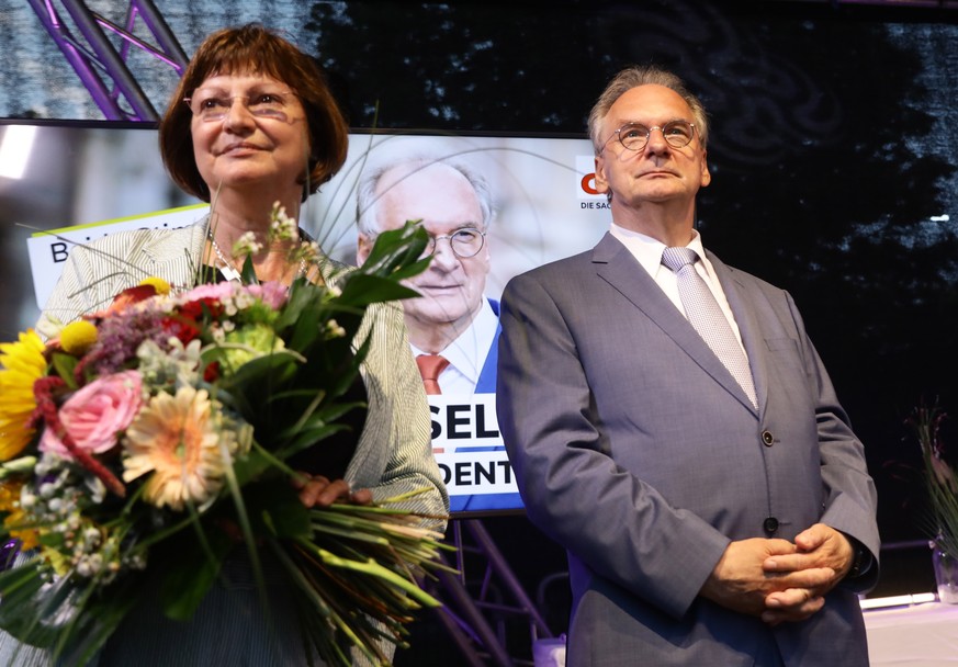 epa09251930 The leading candidate of the German Christian Democratic Party (CDU), Reiner Haseloff (R), and his wife Gabriele (L) wave at the election results party of the CDU following the Saxony-Anha ...