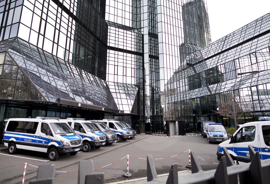 Police cars stand in the backyard of Deutsche Bank headquarters during a raid in Frankfurt, Germany, Thursday, Nov. 29, 2018. (AP Photo/Michael Probst)