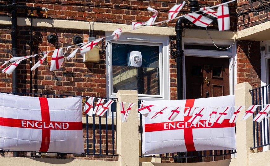 epa09257964 England flags fly from residential flats on the Kirby Estate in Bermondsey, London, Britain, 09 June 2021. The UEFA EURO 2020 soccer tournament was delayed by a year because of the Covid-1 ...