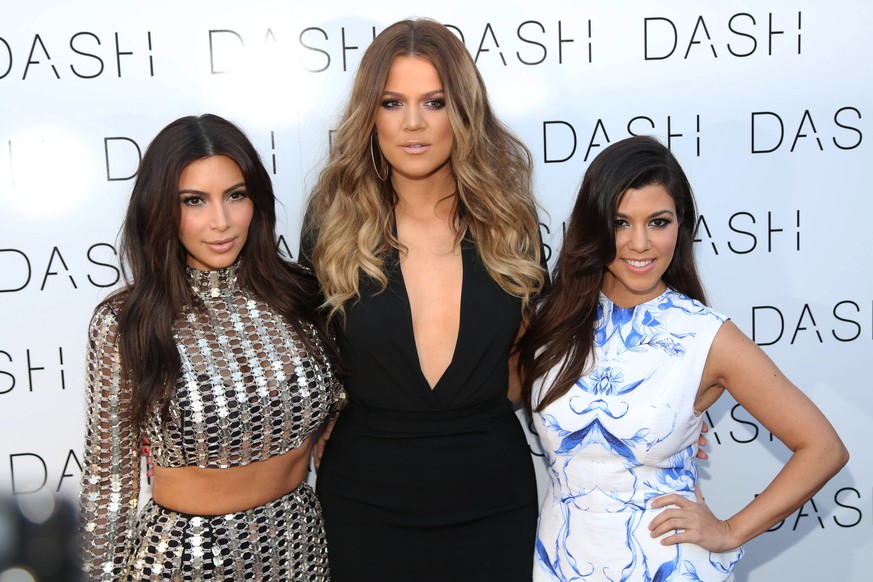 From left, Kim Kardashian, Khloe Kardashian and Kourtney Kardashian attend The Kardashian Family Celebrates the Grand Opening of DASH Miami Beach on Wednesday, March 12, 2014, in Miami Beach, Fla. (Ph ...