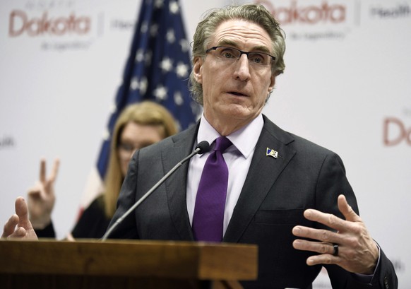 FILE - In this April 10, 2020, file photo, North Dakota Gov. Doug Burgum speaks at the state Capitol in Bismarck, N.D. After months of resisting ordering the people of North Dakota to wear masks and l ...