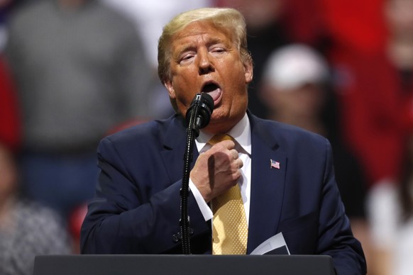 President Donald Trump acts as if he is choking to describe the Democratic debate performance of Michael Bloomberg as Trump speaks at a campaign rally Thursday, Feb. 20, 2020, in Colorado Springs, Col ...