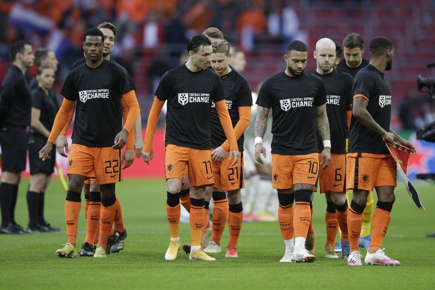 Netherlands&#039; players enters on the field with shirts reading &#039;Football Supports Change&#039; prior to the start of the World Cup 2022 group G qualifying soccer match between The Netherlands  ...