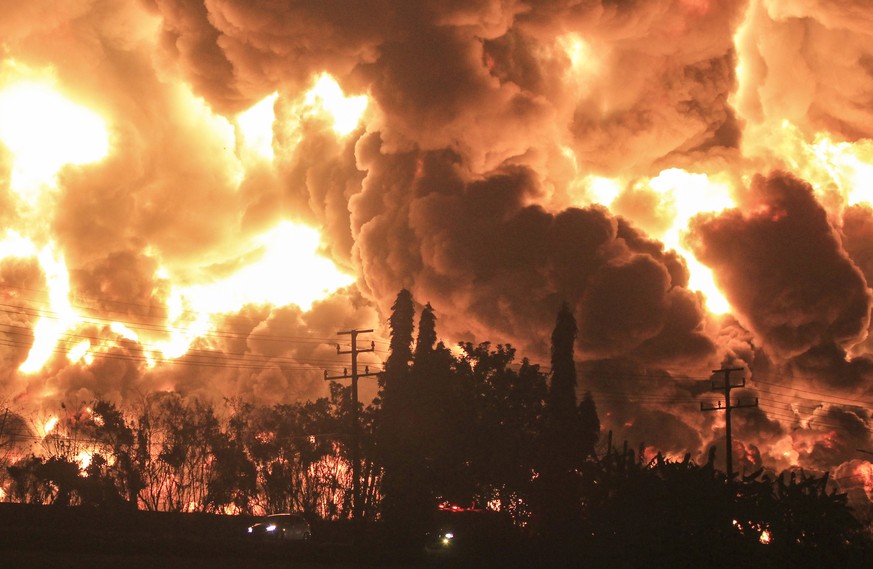 epa09104159 Thick smoke rises during a fire at a state-run Balongan oil refinery in Balongan, Indramayu, Indonesia, 29 March 2021. At least five people had been injured and hundreds of people have bee ...