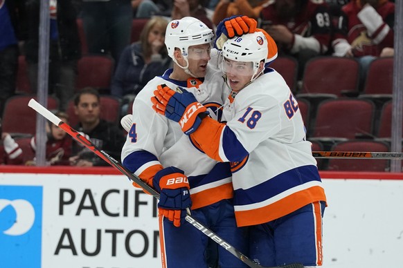 New York Islanders left wing Anthony Beauvillier (18) celebrates with Andy Greene after scoring a goal against the Arizona Coyotes in the third period during an NHL hockey game, Monday, Feb. 17, 2020, ...