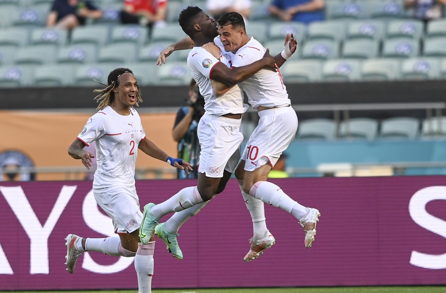 Switzerland&#039;s Breel Embolo celebrates with Granit Xhaka, right, after scoring his side&#039;s opening goal during the Euro 2020 soccer championship group A match between Wales and Switzerland, at ...