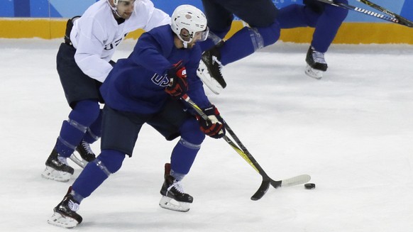 United State&#039;s Ryan Gunderson battles controls the puck against Mark Arcobello, left, during practice ahead of the 2018 Winter Olympics in Gangneung, South Korea, Friday, Feb. 9, 2018. (AP Photo/ ...
