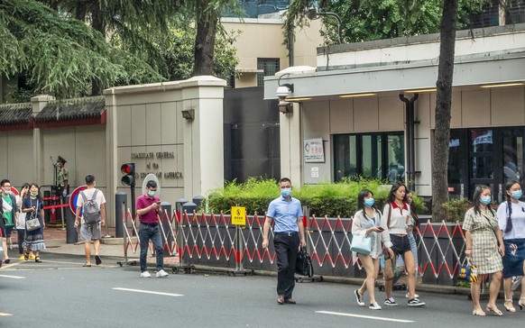 epa08563514 People walk in front of the US consulate in Chengdu, Sichuan province, China, 23 July 2020 (issued 24 July 2020). The US Consulate General in the southwestern Chinese city of Chengdu has b ...