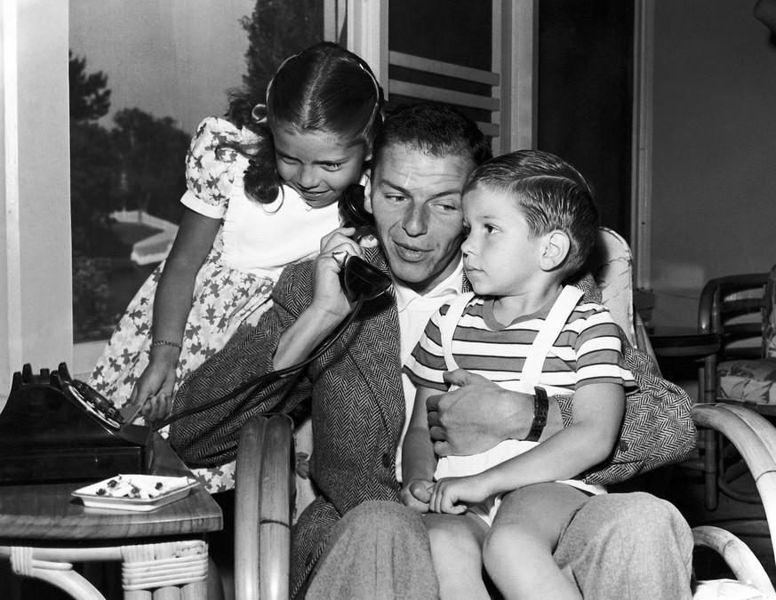 In this 1948 file photo, Frank Sinatra holds a telephone with his children, Nancy and Frank Jr., in the Hollywood area of Los Angeles. Frank Sinatra Jr., who carried on his famous father&#039;s legacy ...