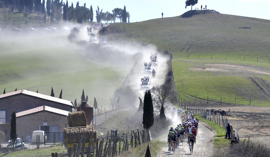 The pack pedals in the typical Tuscan landscape during the &quot;Strade Bianche&quot; (White Roads) cycling race in Siena, Central Italy, Saturday, March 3, 2012. (AP Photo/Daniele Badolato,LaPresse)  ...