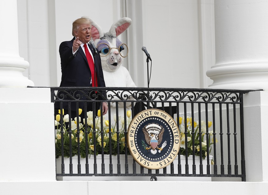 DAY 88 - In this April 17, 2017, file photo, President Donald Trump, joined by the Easter Bunny, speaks from the Truman Balcony during the annual White House Easter Egg Roll on the South Lawn of the W ...