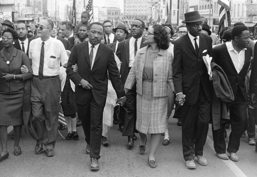 This photo released by the High Museum of Art, shows Dr. Martin Luther King Jr. and his wife Coretta Scott King leading freedom marchers in Montgomery, Ala. in 1965, in a photo by Morton Broffman, whi ...