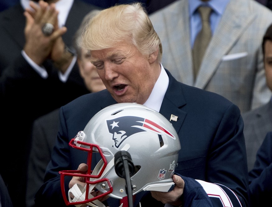 President Donald Trump is presented with a New England Patriots football helmet by Patriots head coach Bill Belichick and New England Patriots owner Robert Kraft during a ceremony on the South Lawn of ...