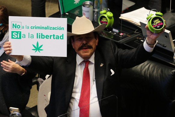 epa08830188 Senator Armando Guadiana celebrates the passing of a bill to legalize adult-use cannabis, in Mexico City, Mexico, 19 November 2020. On 19 November, the Mexican Senate approved legalizing r ...