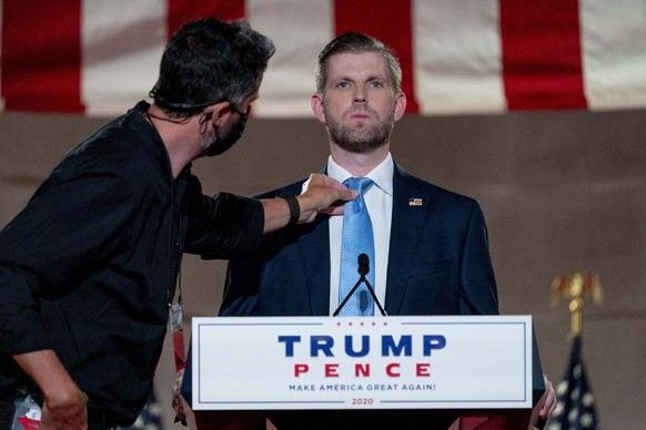 Eric Trump, the son of President Donald Trump, has his tie adjusted before taping his speech for the second day of the Republican National Convention from the Andrew W. Mellon Auditorium in Washington ...