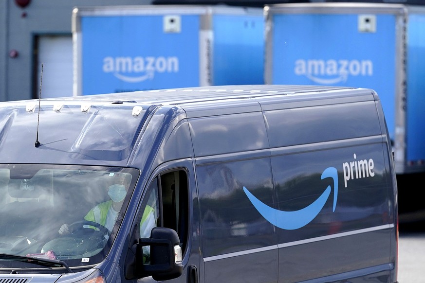 FILE - In this Oct. 1, 2020 file photo, an Amazon Prime logo appears on the side of a delivery van as it departs an Amazon Warehouse location in Dedham, Mass. Amazon is paying nearly $62 million to se ...