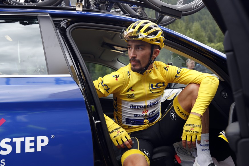 France&#039;s Julian Alaphilippe wearing the overall leader&#039;s yellow jersey sits in the team director car during the nineteenth stage of the Tour de France cycling race over 126,5 kilometers (78, ...