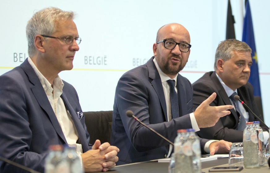 Belgian Prime Minister Charles Michel, center, speaks during a media conference at the prime ministers office in Brussels on Sunday, Aug. 7, 2016. A man attacked two police officers with a machete nea ...