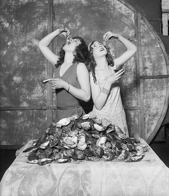 (Original Caption) Here are Lois and Ruth Waddell of the follies, who at a single sitting devoured 204 oysters betweenthem - equally divided of course. The girls were judged the winners in the great o ...