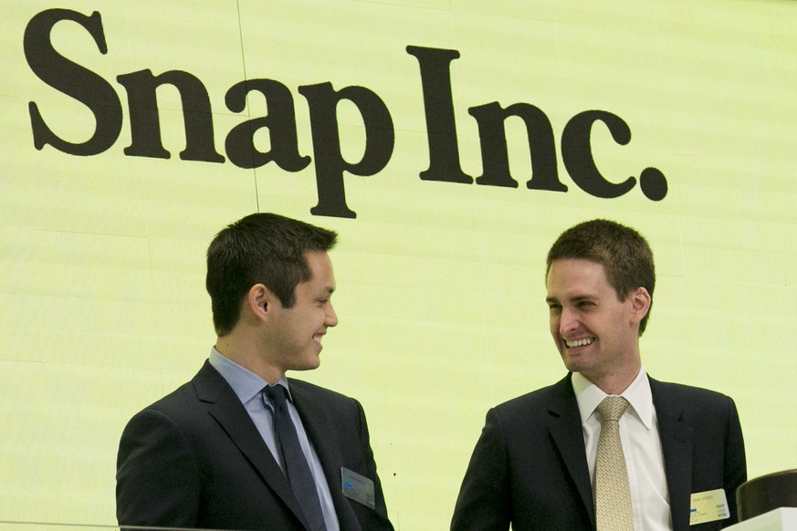 FILE - In this Thursday, March 2, 2017, file photo, Snap co-founders Bobby Murphy, left, and CEO Evan Spiegel ring the opening bell at the New York Stock Exchange as the company celebrates its IPO. Sn ...