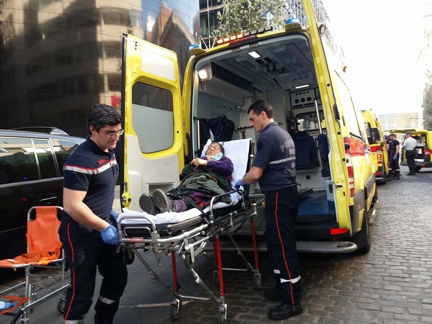 Medics help an injured woman after several people were injured and taken to hospital following clashes between supporters and opponents of the Turkish government outside the country&#039;s consulate i ...