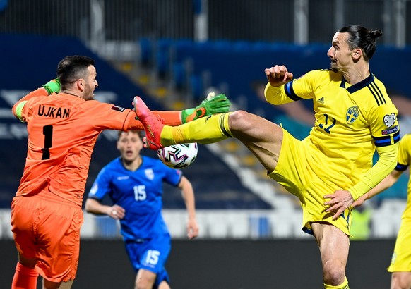 epa09103625 Zlatan Ibrahimovic (R) of Sweden in action against goalkeeper Samir Ujkani of Kosovo (L) during the FIFA World Cup 2022 qualifying soccer match between Kosovo and Sweden in Pristina, Kosov ...