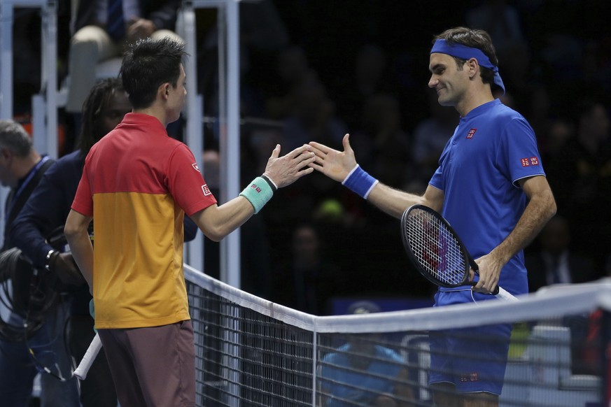 Japan&#039;s Kei Nishikori shakes hands with Switzerland&#039;s Roger Federer after Nishikori won their ATP World Tour Finals singles final tennis match at the O2 Arena in London, Sunday Nov. 11, 2018 ...