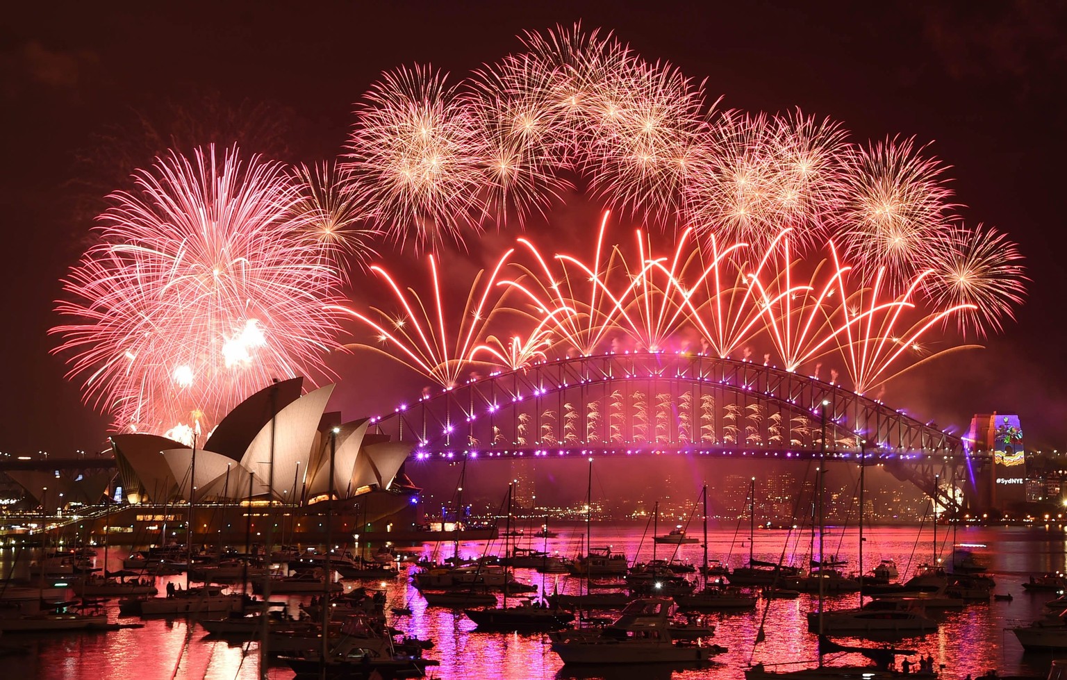 epa05692599 The New Year&#039;s Eve Fireworks illuminate the sky above Sydney Harbour with its Opera House and Harbour Bridge, taken from Mrs Macquarie&#039;s Point in Sydney, Australia, 31 December 2 ...