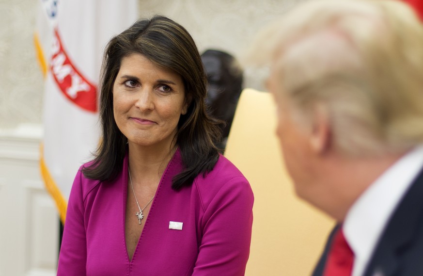 epa07081170 US Ambassador to the United Nations Nikki Haley (L) listens to US President Donald J. Trump (R) deliver remarks to members of the news media in the Oval Office of the White House in Washin ...