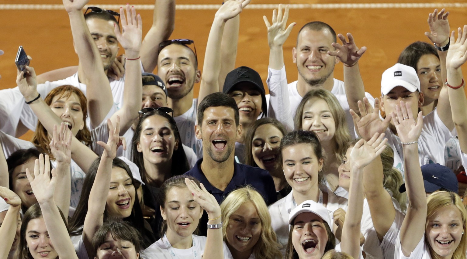 epa08503560 (FILE) - Novak Djokovic of Serbia (C) poses for a photo with volunteers at the Adria Tour tennis tournament in Belgrade, Serbia, 14 June 2020 (reissued 23 June 2020). According to media re ...