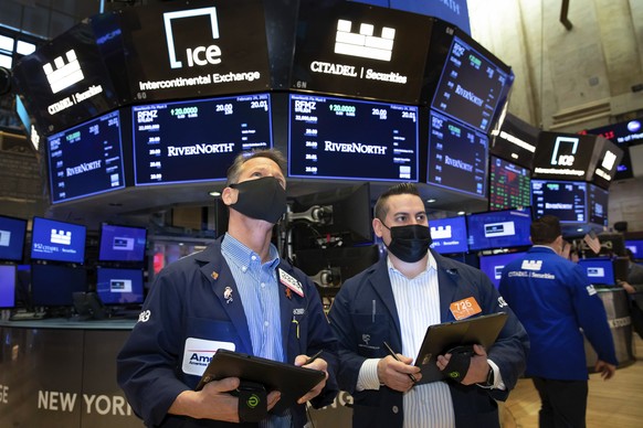 In this photo provided by the New York Stock Exchange, traders work on the floor, Wednesday, Feb. 24, 2021. Stocks shook off a weak start and moved broadly higher in afternoon trading on Wall Street,  ...