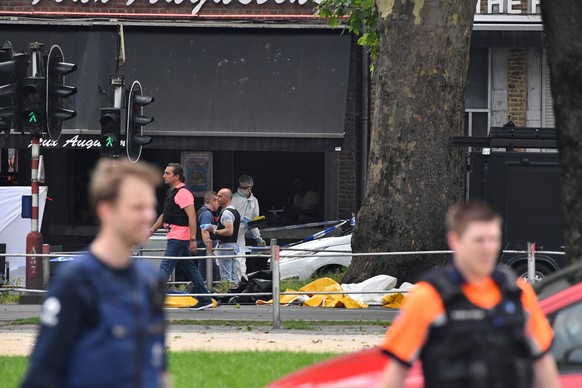 Police investigate at the scene of a shooting in Liege, Belgium, Tuesday, May 29, 2018. A gunman killed three people, including two police officers, in the Belgian city of Liege on Tuesday, a city off ...