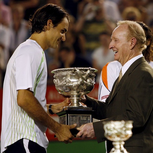 Switzerland&#039;s Roger Federer (L) receives the winning trophy from Rod Laver after defeating Marcos Baghdatis from Cyprus in the men&#039;s singles final at the Australian Open Tennis in Melbourne, ...