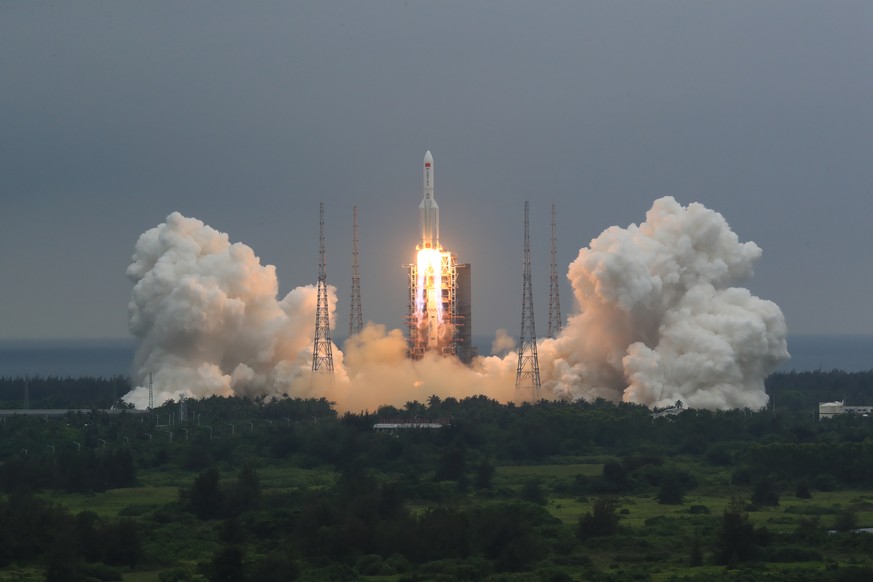 FILE - In this April 29, 2021, file photo released by China&#039;s Xinhua News Agency, a Long March 5B rocket carrying a module for a Chinese space station lifts off from the Wenchang Spacecraft Launc ...