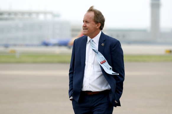 FILE - In this June 28, 2020 file photo, Texas&#039; Attorney General Ken Paxton waits on the flight line for the arrival of Vice President Mike Pence at Love Field in Dallas. A longshot lawsuit that  ...