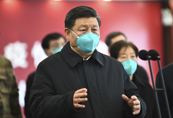 FILE - In this March 10, 2020 file photo released by China&#039;s Xinhua News Agency, Chinese President Xi Jinping talks by video with patients and medical workers at the Huoshenshan Hospital in Wuhan ...