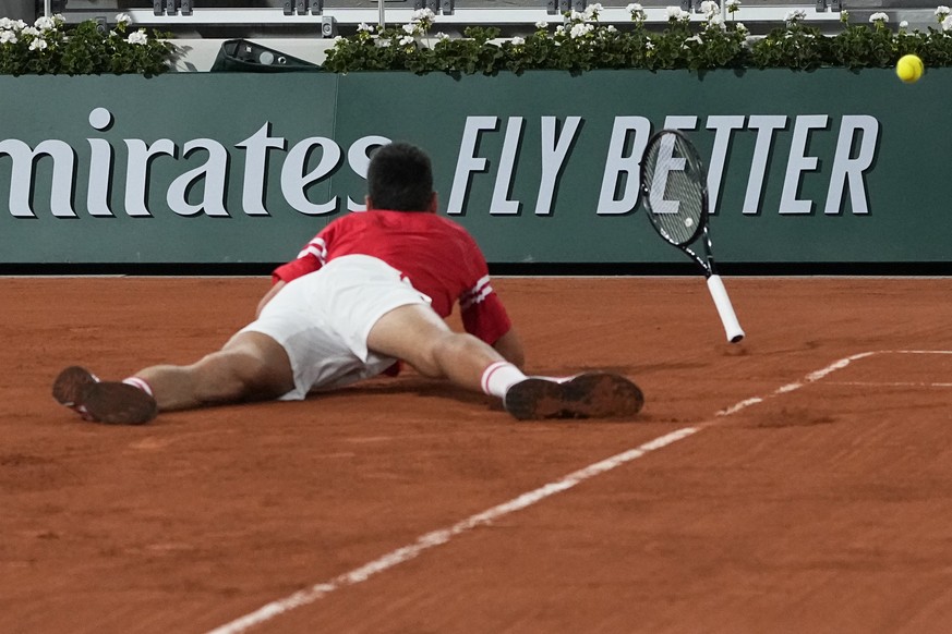 Serbia&#039;s Novak Djokovic falls as he plays Italy&#039;s Matteo Berrettini in a quarterfinal match of the French Open tennis tournament at the Roland Garros stadium Wednesday, June 9, 2021 in Paris ...