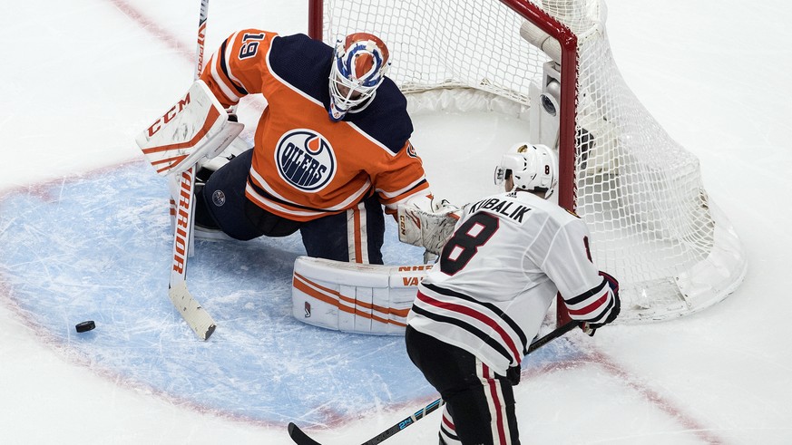 Edmonton Oilers goalie Mikko Koskinen (19) makes a save against Chicago Blackhawks&#039; Dominik Kubalik (8) during third-period NHL hockey Stanley Cup playoff game action in Edmonton, Alberta, Saturd ...