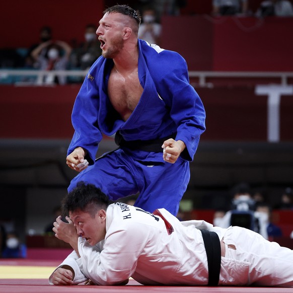 epa09379308 Luka Krpalek of Czech Republic (blue) reacts while fighting with Hisayoshi Harasawa of Japan (white) during the Men +100 kg Semifinal Table B contest at the Judo events of the Tokyo 2020 O ...
