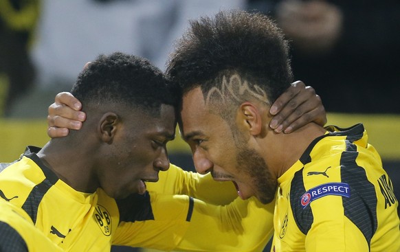 FILE - In this March 8, 2017 file photo Dortmund&#039;s Ousmane Dembele, left, congratulates Dortmund&#039;s Pierre-Emerick Aubameyang as they celebrate after scoring the opening goal during the Champ ...
